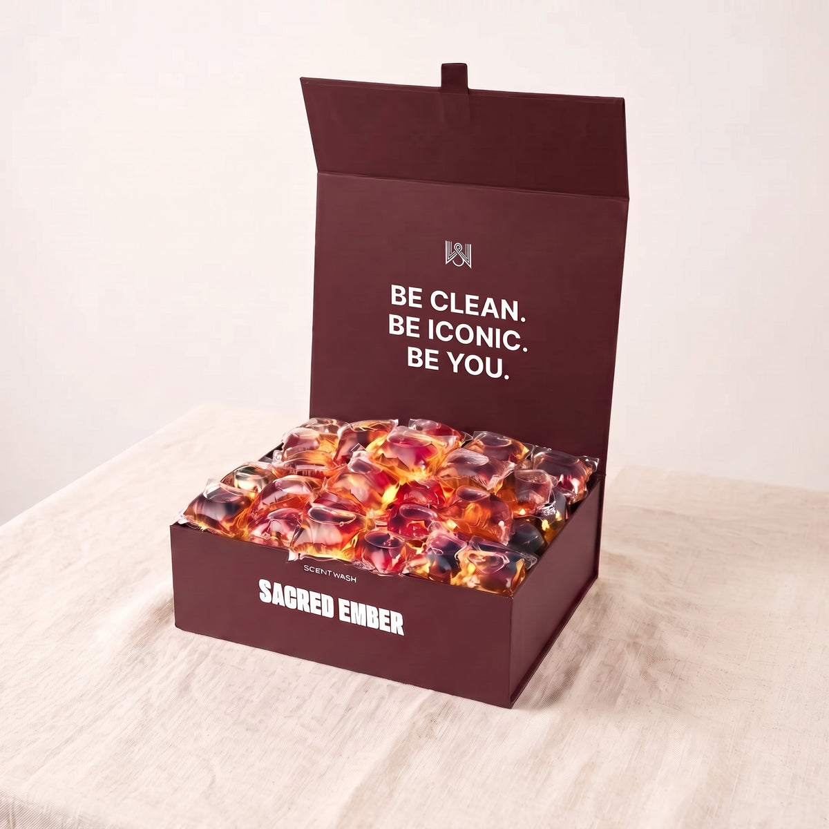 Sacred Ember laundry pods box, open, on linen